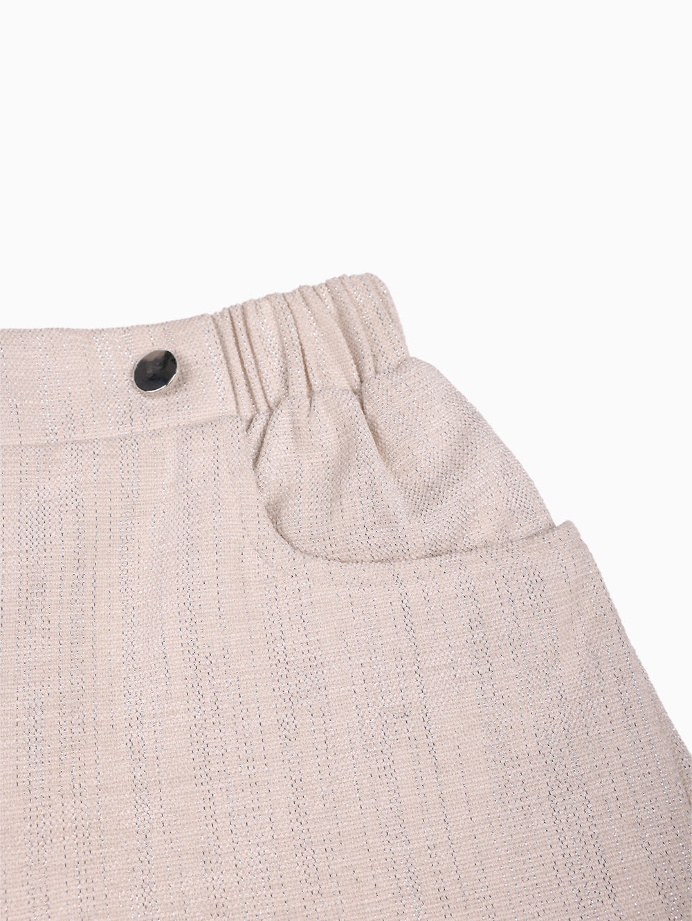 Back view of Overkids beige girls’ shorts with elastic waistband.