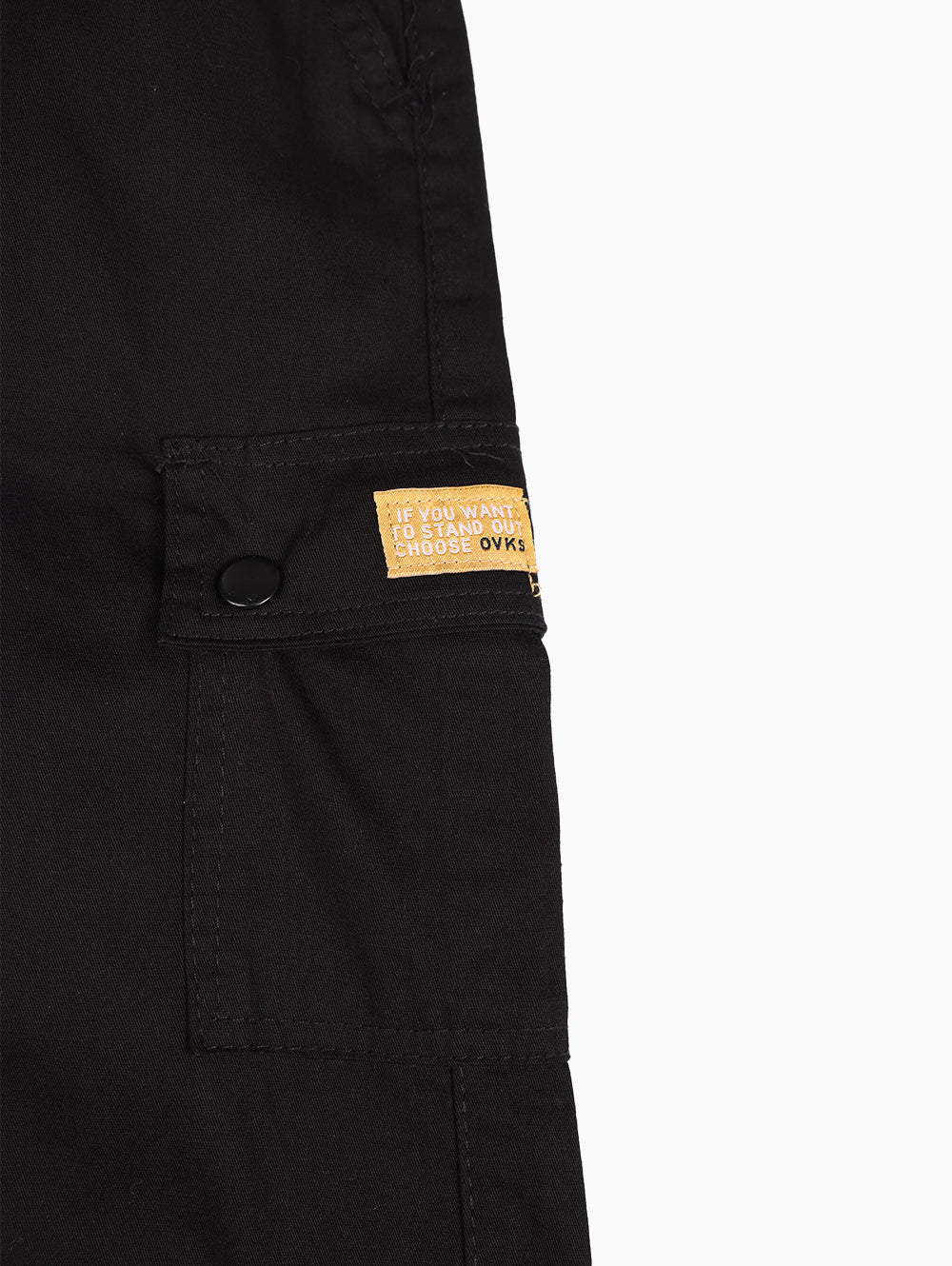 Close-up of yellow Overkids logo patch detail on pocket