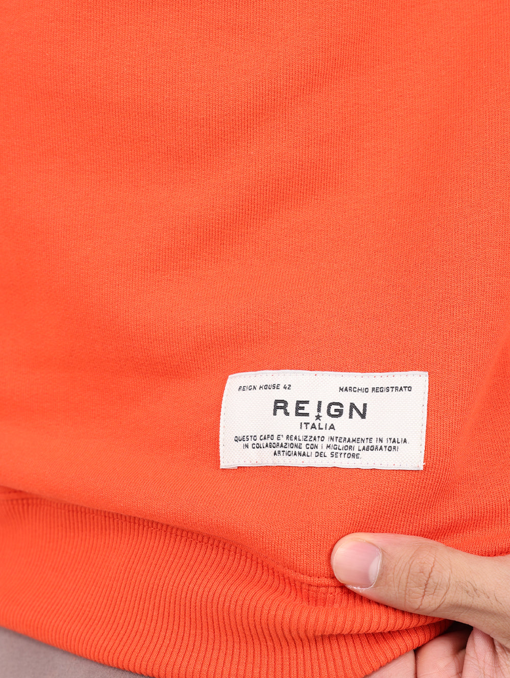Reign Italia logo patch detail on Orange sweatshirt