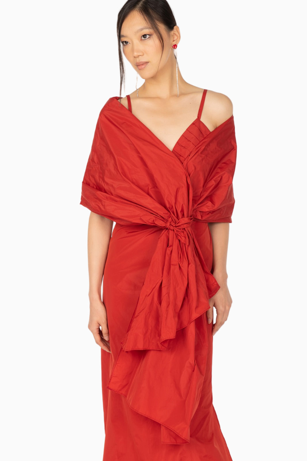 Close-up of Siste’s red silk dress pleated bodice details